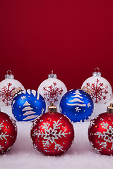 Image showing Christmas balls over a red background