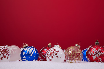 Image showing Christmas balls over a red background