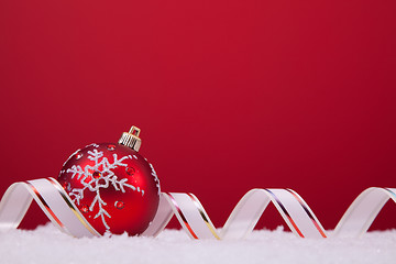 Image showing Christmas balls over a red background