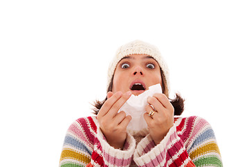 Image showing woman sneezing to a tissue