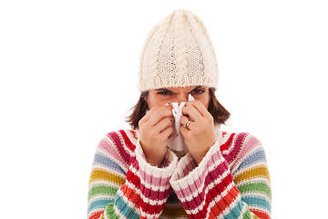 Image showing woman sneezing to a tissue