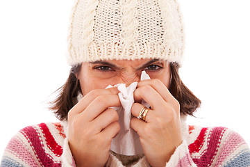 Image showing woman sneezing to a tissue