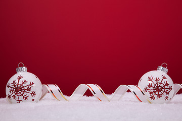 Image showing Christmas balls over a red background
