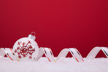 Image showing Christmas balls over a red background