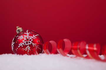 Image showing Christmas balls over a red background