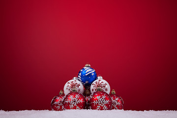 Image showing Christmas balls over a red background