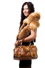 Image showing Woman stand with fur and bag