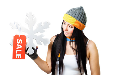 Image showing Woman hold snowflake with sale tag