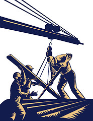 Image showing Construction workers hoisting timber