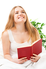Image showing Woman read book sitting in bed