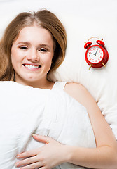 Image showing Woman lay on pillow with alarm