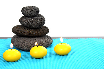 Image showing candles and massage stones in a calm zen spa