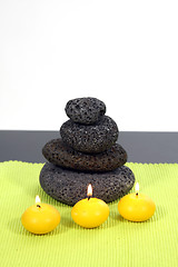 Image showing candles and massage stones in a calm zen spa