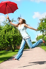Image showing girl jumps with umbrella