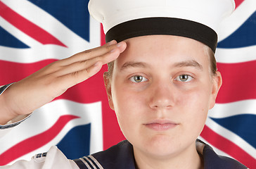 Image showing young sailor saluting in front of union jack