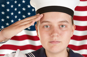 Image showing young sailor saluting in front of US flag