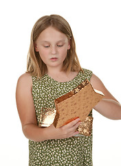 Image showing girl opening present on white