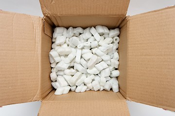Image showing A cardboard box with packing foam pellets top view