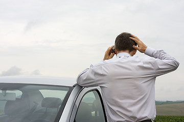 Image showing Worried businessman talking on cell phone