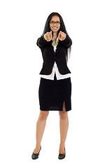 Image showing Young smiling business woman pointing