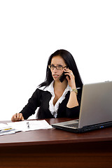 Image showing woman working with laptop holding phone