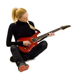 Image showing girl playing an electric guitar sitting down