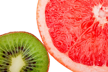 Image showing Macro shot of a red grapefruit and a kiwi isolated on white