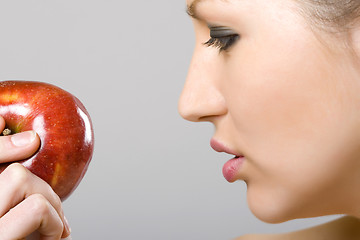 Image showing woman looking at an apple