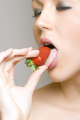 Image showing woman eating strawberry