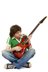 Image showing  seated guitarist playing an electric guitar