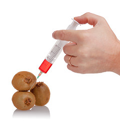 Image showing  hand holds the syringe on kiwi