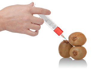 Image showing  hand holds the syringe on kiwi