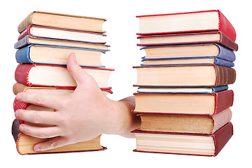 Image showing pile of old books and hand