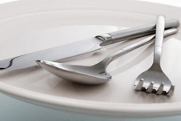 Image showing empty plate, fork, spoon and table-knife