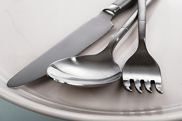 Image showing empty plate, fork, spoon and table-knife