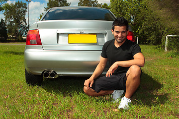 Image showing Smiling happy man beside car