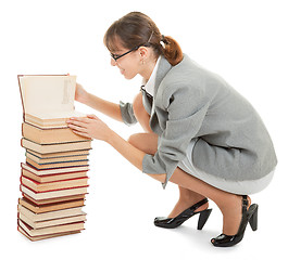 Image showing woman and a pile of books