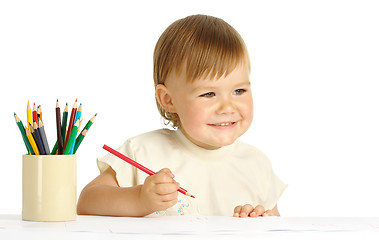 Image showing Child draw with red crayon