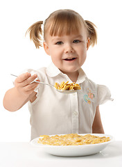 Image showing Girl showing spoon filled with corn flakes
