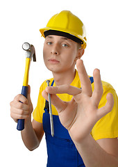 Image showing Young serene worker with hammer and nail