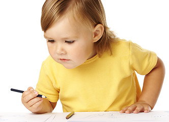 Image showing Child half-rise from table, playing with crayons