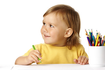Image showing Cute child draw with crayons and smile