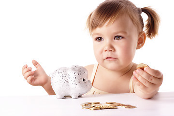 Image showing Cute little girl with piggybank