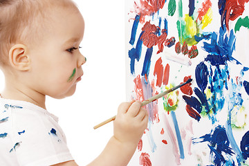 Image showing Little girl paint on a board