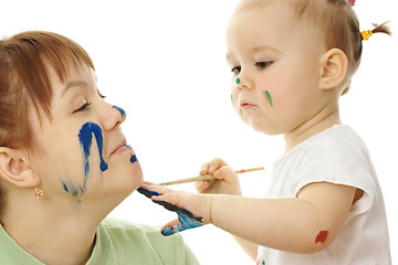 Image showing Little girl paint on her mother