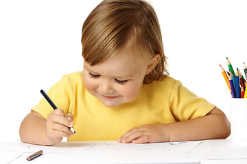 Image showing Playful child draw with crayons and smile