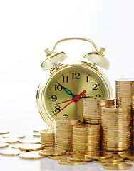 Image showing Time is money - clock dial and golden coins