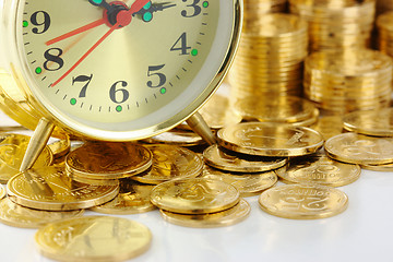 Image showing Time is money - clock dial and golden coins