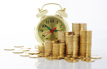 Image showing Time is money - clock dial and golden coins