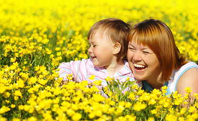 Image showing Mother and child play on meadow